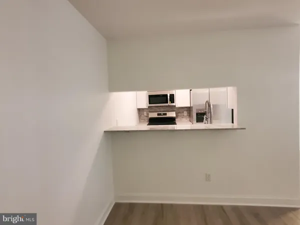 a view of kitchen with stainless steel appliances cabinets