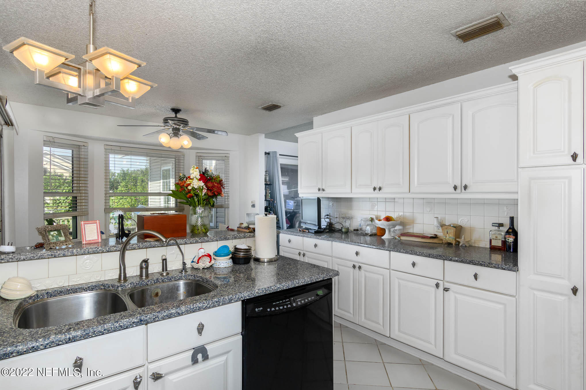 7047 Rivercrest Drive Jacksonville, FL 32226 - Photo 12 of 29 a kitchen with sink cabinets and chandelier