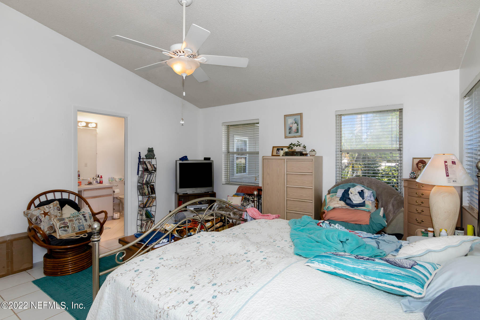 7047 Rivercrest Drive Jacksonville, FL 32226 - Photo 14 of 29 a bedroom with bed a window and gym equipment