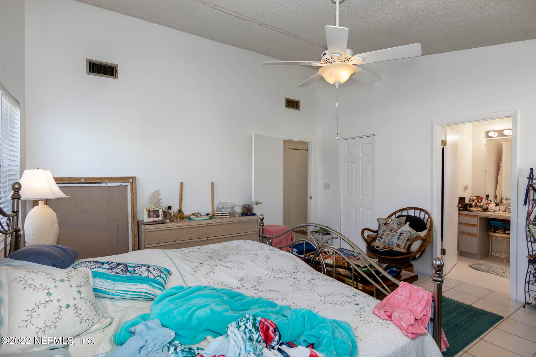 7047 Rivercrest Drive Jacksonville, FL 32226 - Photo 16 of 29 a bedroom with bed and a chandelier