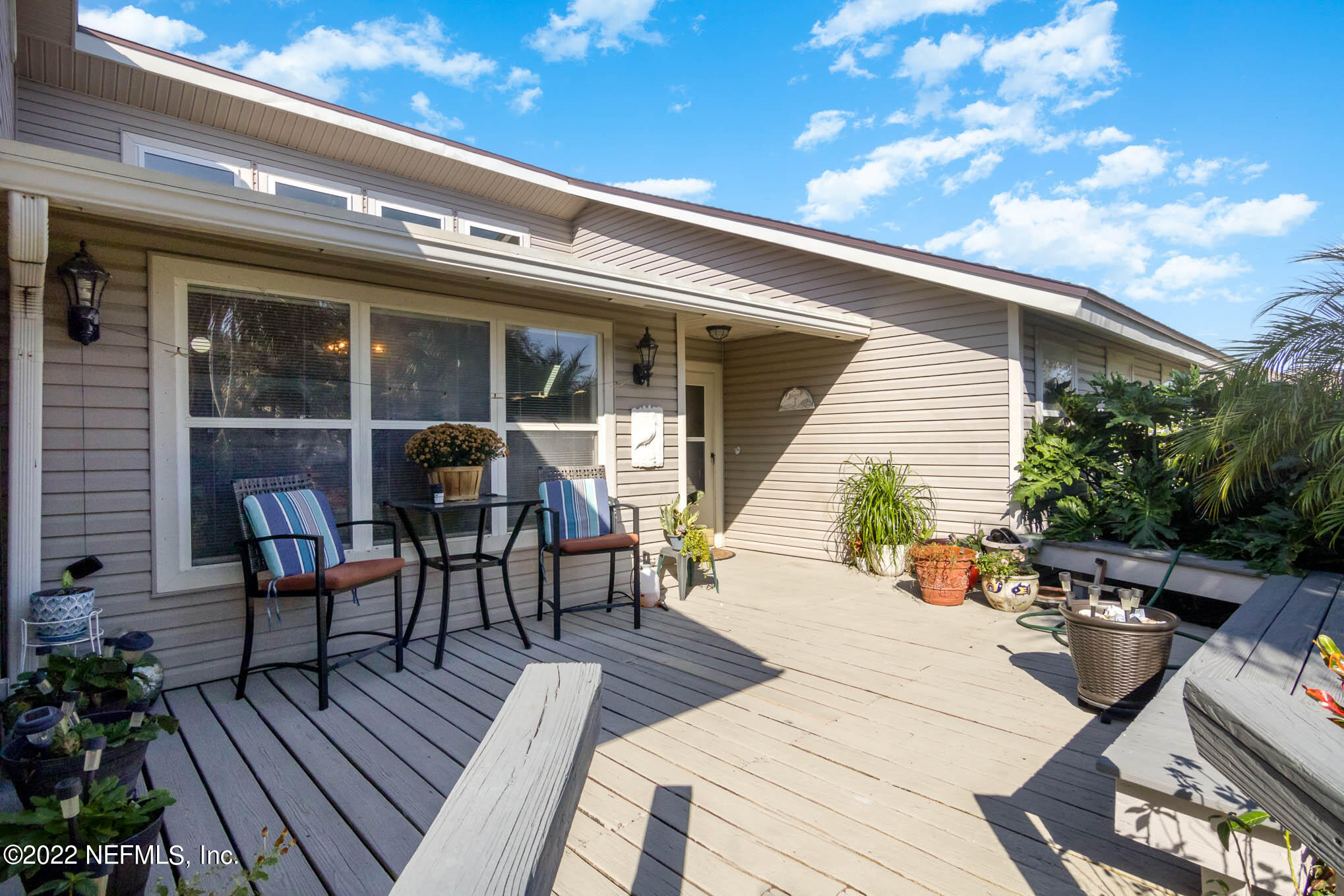 7047 Rivercrest Drive Jacksonville, FL 32226 - Photo 28 of 29 a view of a patio with table and chairs with wooden floor and fence