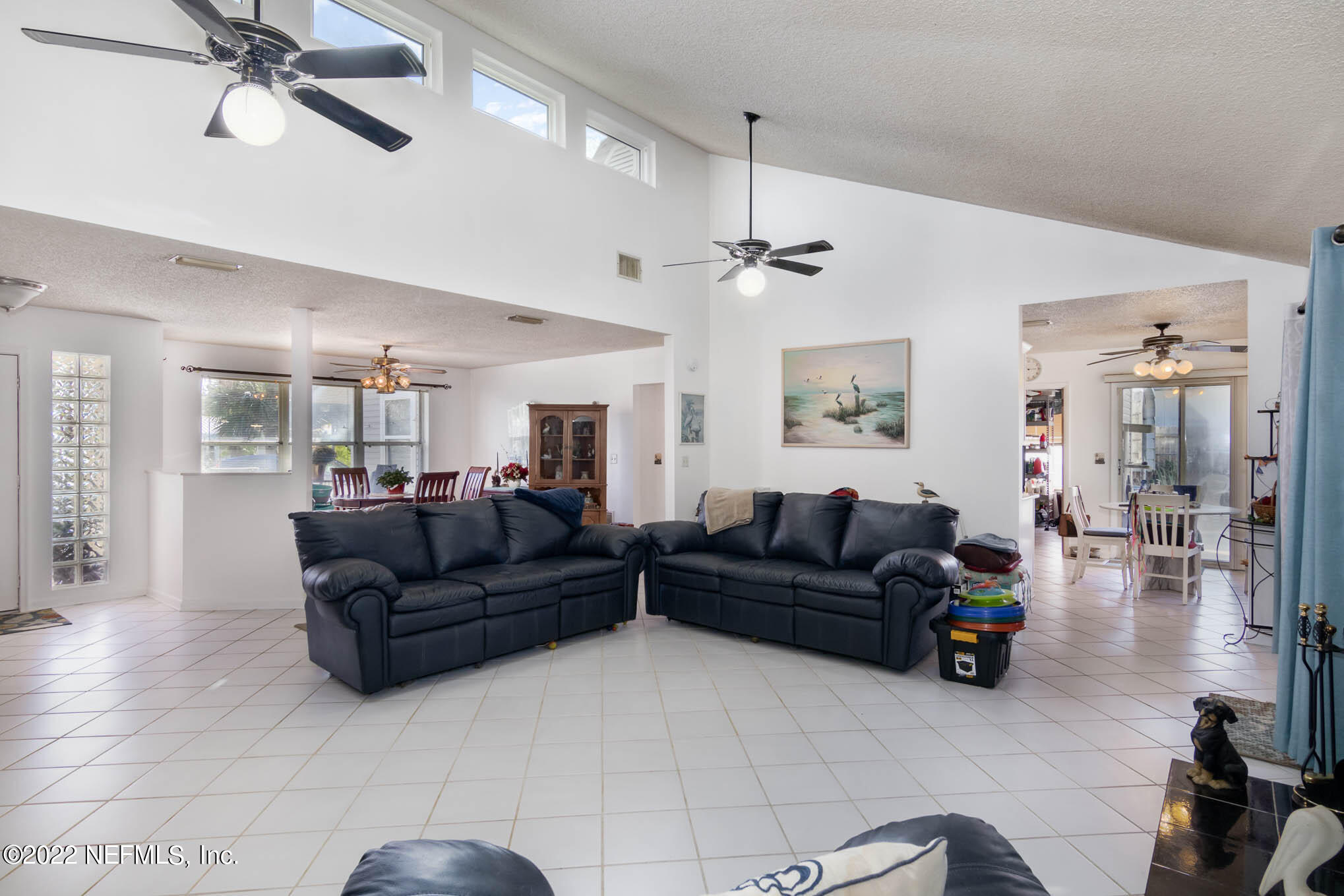 7047 Rivercrest Drive Jacksonville, FL 32226 - Photo 4 of 29 a living room with furniture and a chandelier
