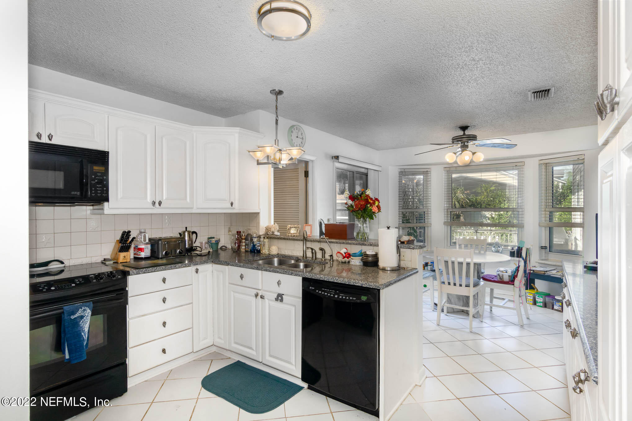 7047 Rivercrest Drive Jacksonville, FL 32226 - Photo 9 of 29 a kitchen with a sink stove and cabinets