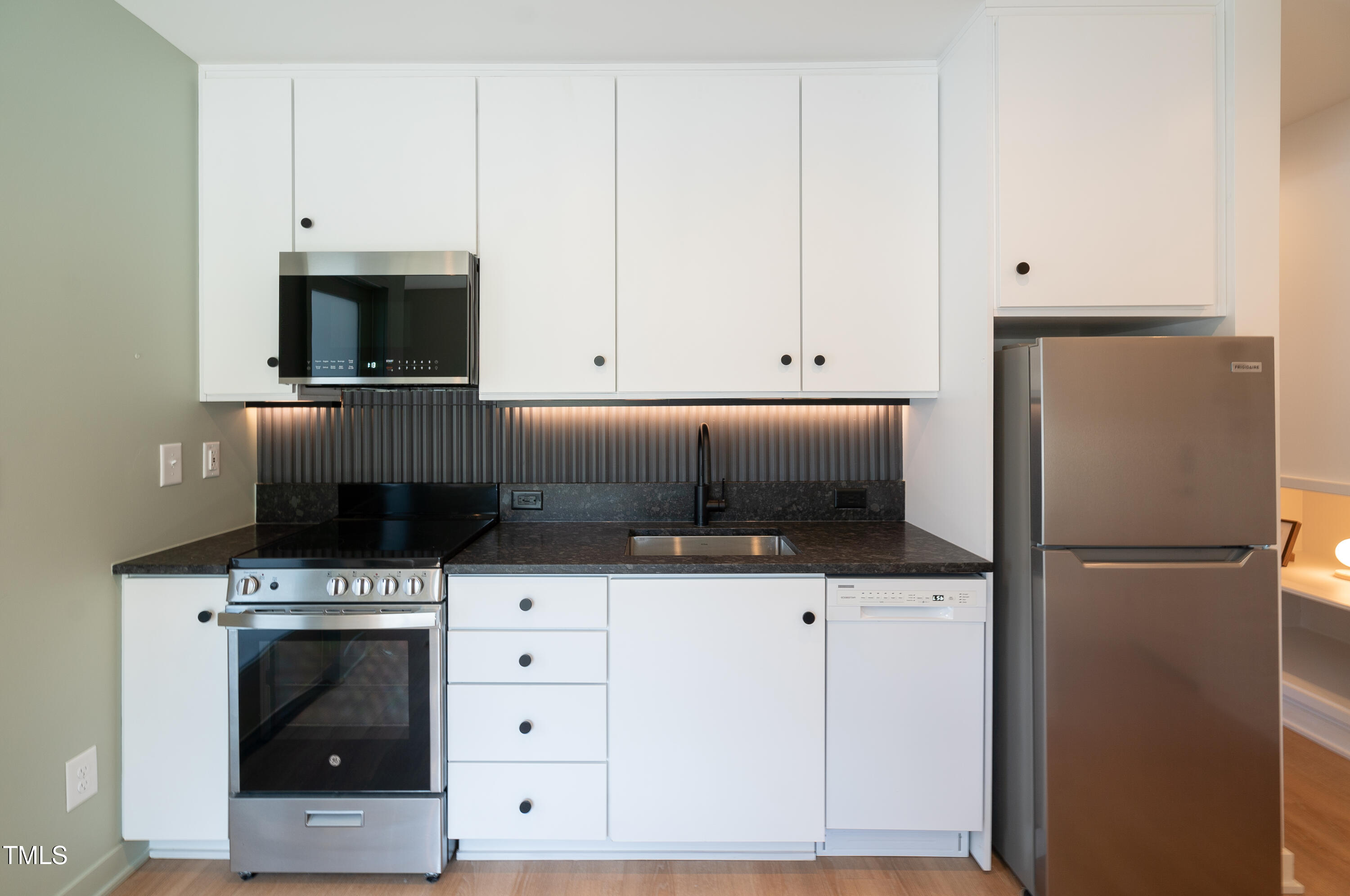 901 East Edenton Street, Unit 1 Raleigh, NC 27601 - Photo 1 of 17 a kitchen with white cabinets and stainless steel appliances