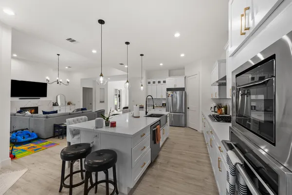 a kitchen with stainless steel appliances kitchen island granite countertop a sink and cabinets