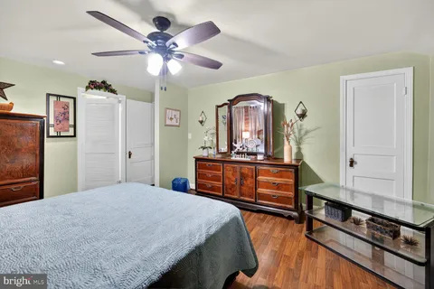a bedroom with furniture and wooden floor