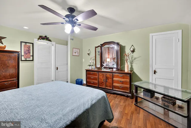 a bedroom with furniture and wooden floor