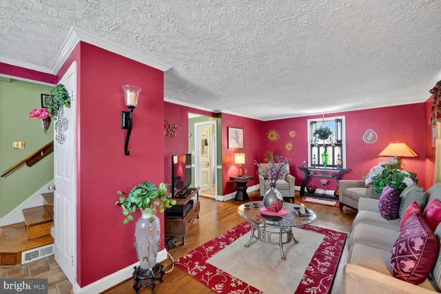 a living room with furniture potted plant and a fireplace