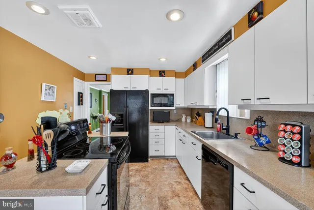 a kitchen with refrigerator and cabinets