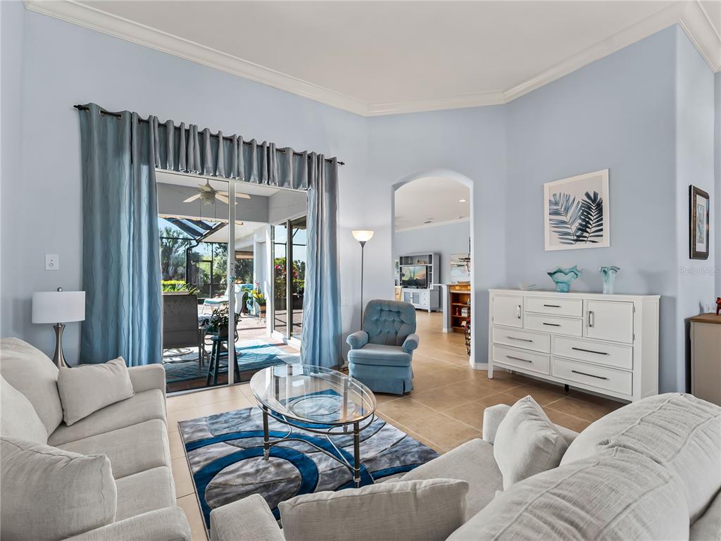 918 Chickadee Drive Venice, FL 34285 - Photo 11 of 85 a living room with furniture and a large window