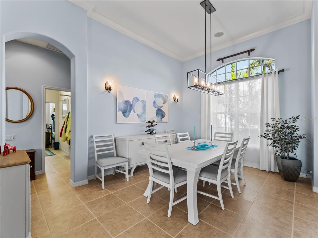 918 Chickadee Drive Venice, FL 34285 - Photo 13 of 85 a dining room with furniture a chandelier and window
