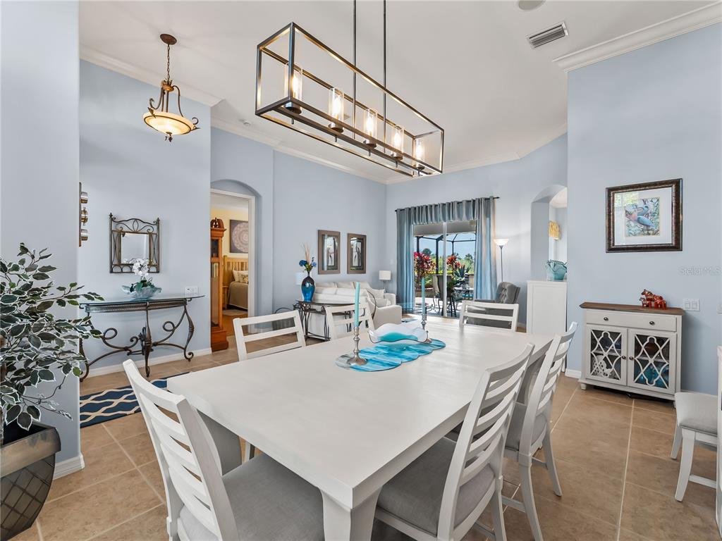 918 Chickadee Drive Venice, FL 34285 - Photo 14 of 85 a view of a dining room with furniture and a chandelier