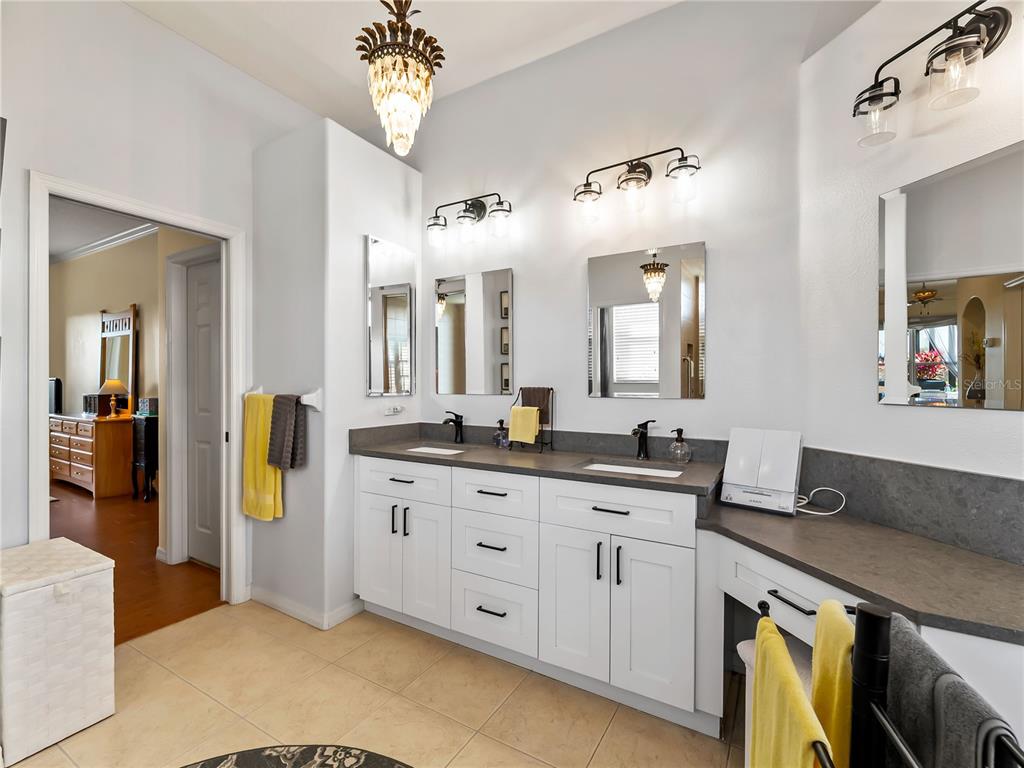 918 Chickadee Drive Venice, FL 34285 - Photo 24 of 85 a spacious bathroom with a granite countertop sink and a mirror