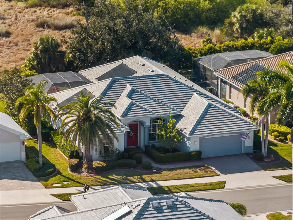 918 Chickadee Drive Venice, FL 34285 - Photo 3 of 85 a front view of a house with swimming pool and sitting area