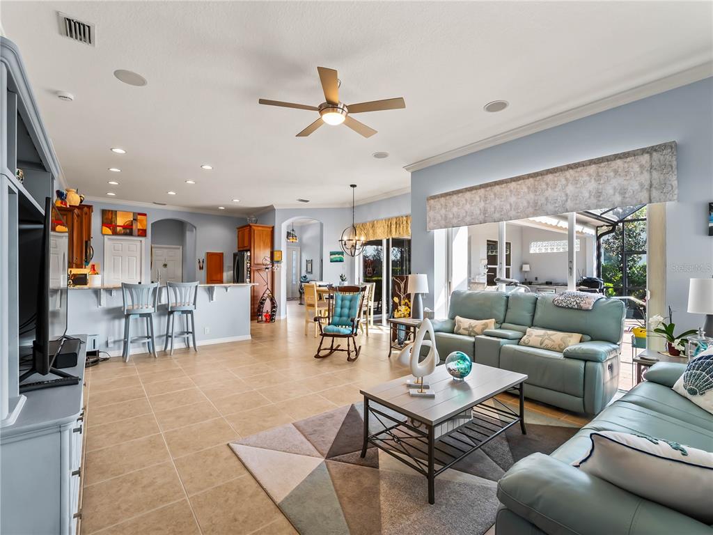 918 Chickadee Drive Venice, FL 34285 - Photo 33 of 85 a living room with furniture kitchen view and a large window