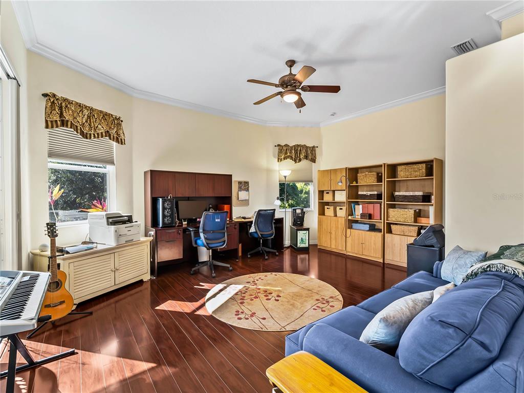 918 Chickadee Drive Venice, FL 34285 - Photo 44 of 85 a living room with furniture and a wooden floor