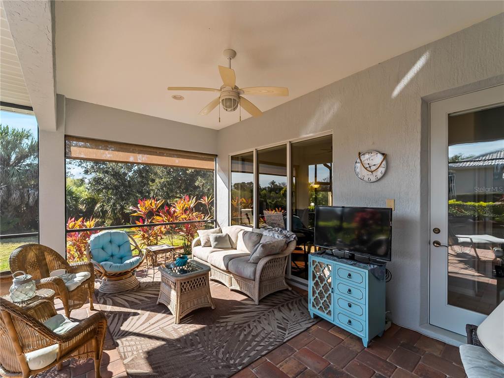 918 Chickadee Drive Venice, FL 34285 - Photo 53 of 85 a living room with furniture a flat screen tv and a large window