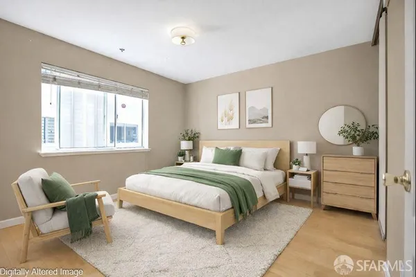 a bedroom with a bed and window