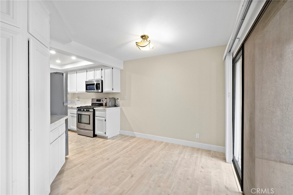 6 Fieldflower Irvine, CA 92614 - Photo 10 of 37 a kitchen with white cabinets and stainless steel appliances
