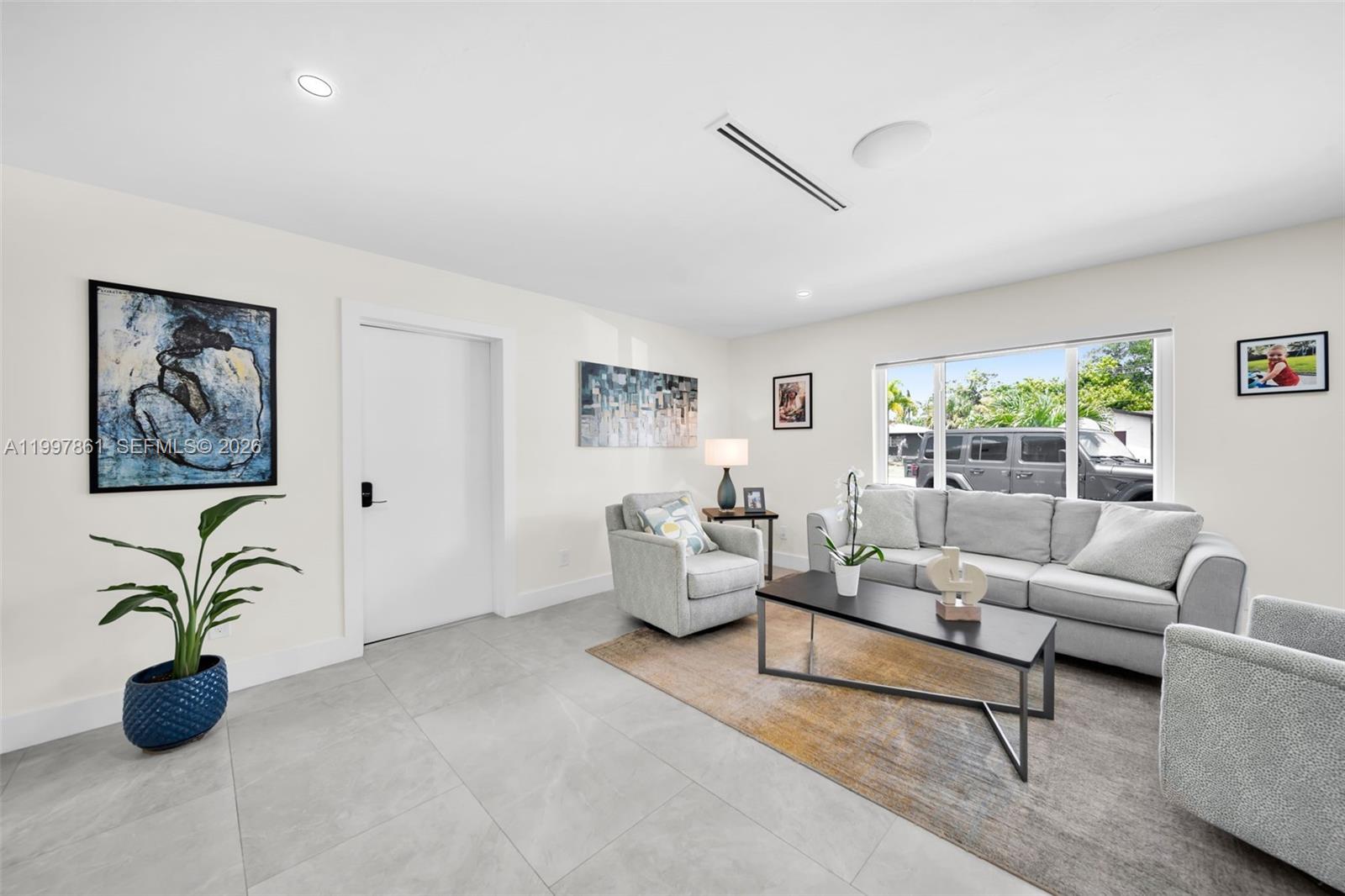 1574 Ricardo Avenue Fort Myers, FL 33901 - Photo 11 of 59 a living room with furniture potted plant and a window