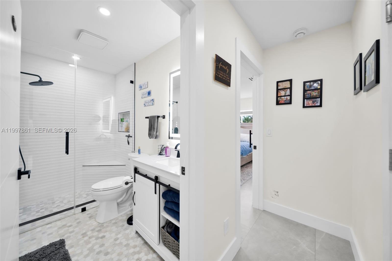 1574 Ricardo Avenue Fort Myers, FL 33901 - Photo 16 of 59 a bathroom with a sink toilet vanity and shower