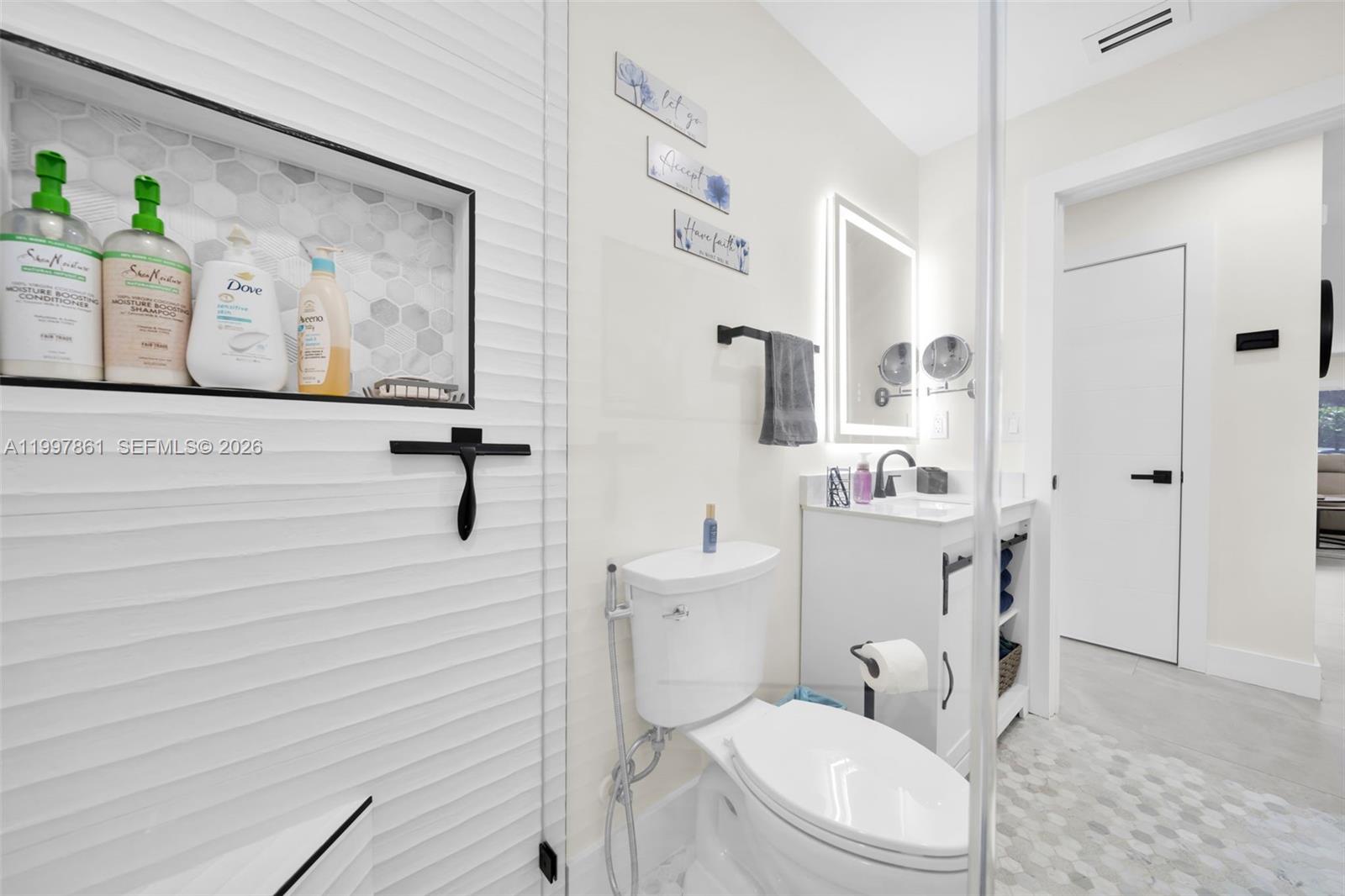 1574 Ricardo Avenue Fort Myers, FL 33901 - Photo 18 of 59 a white toilet sitting next to a bathroom sink