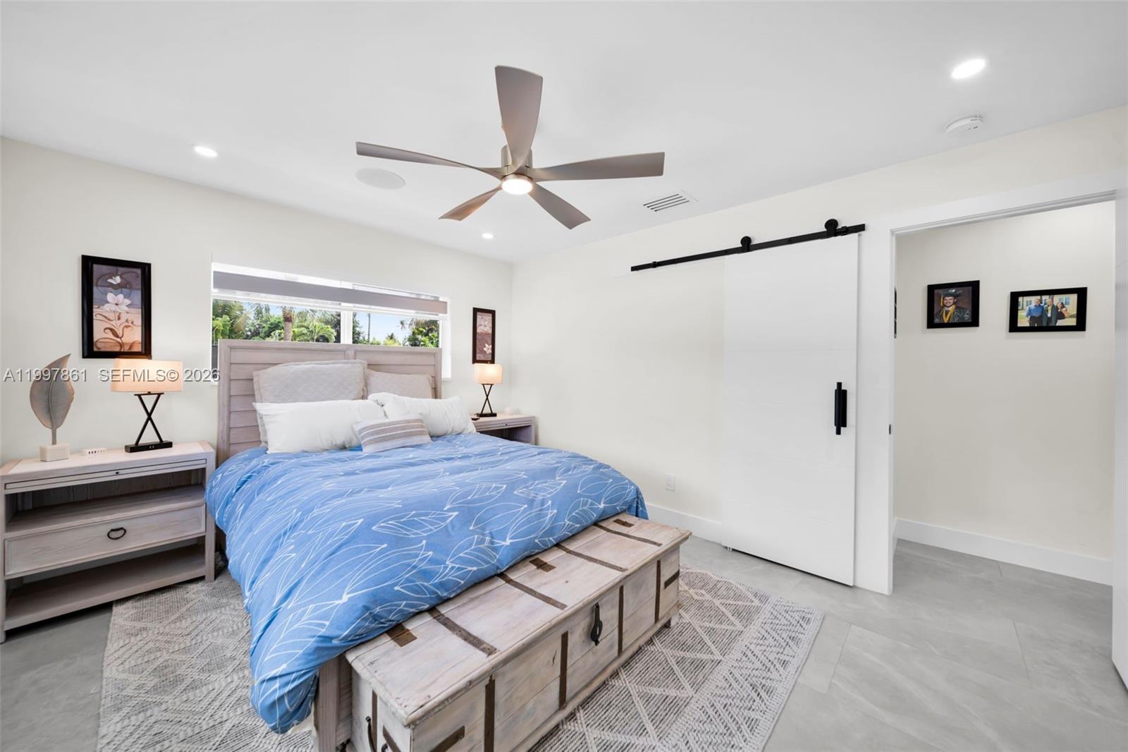 1574 Ricardo Avenue Fort Myers, FL 33901 - Photo 20 of 59 a bedroom with a bed and a chandelier