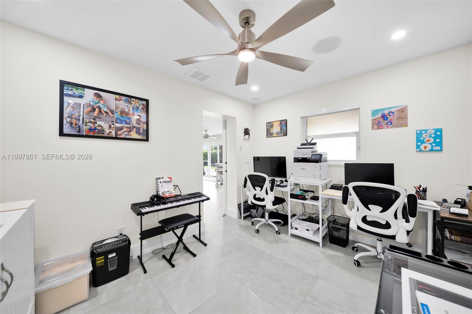 1574 Ricardo Avenue Fort Myers, FL 33901 - Photo 24 of 59 a view of a workspace with furniture and a ceiling fan
