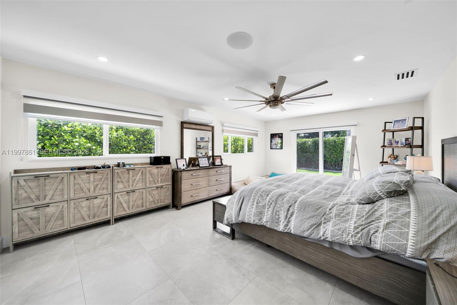 1574 Ricardo Avenue Fort Myers, FL 33901 - Photo 27 of 59 a bedroom with a large bed and windows