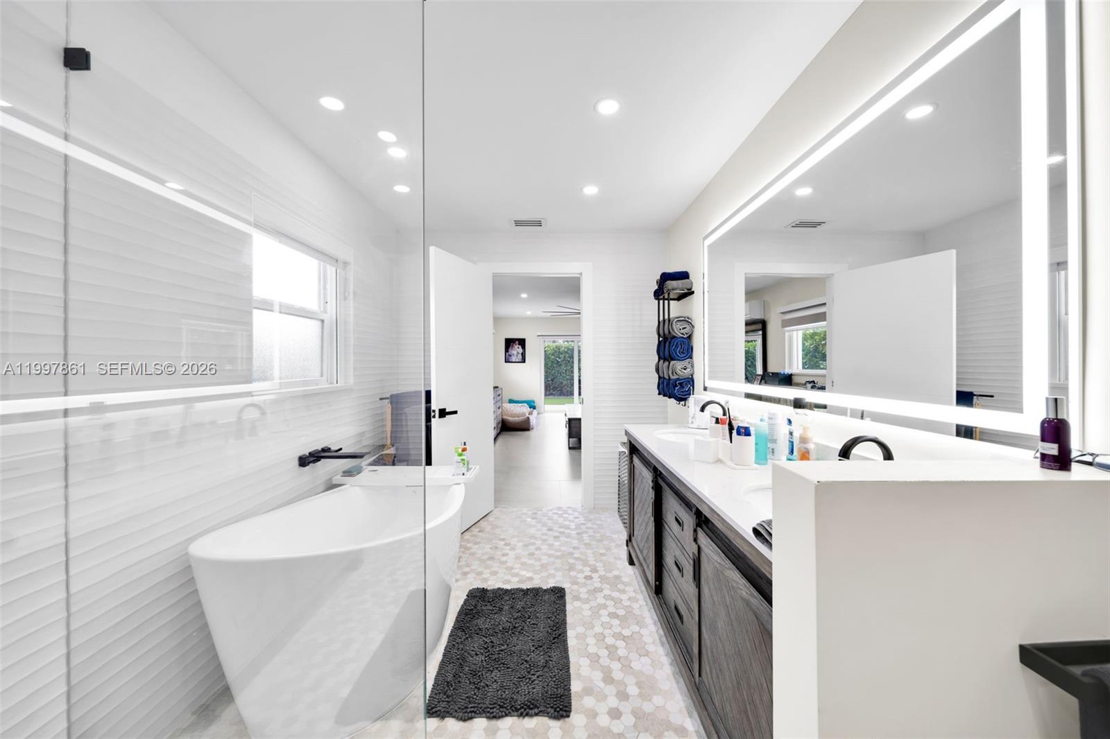 1574 Ricardo Avenue Fort Myers, FL 33901 - Photo 32 of 59 a large bathroom with a large tub sink shower and mirror