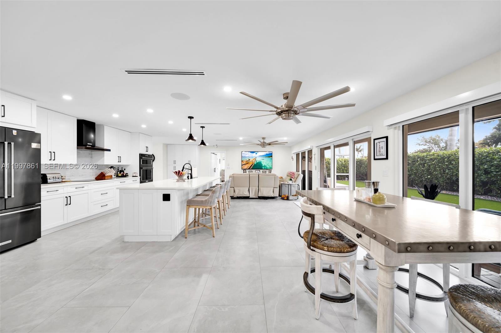 1574 Ricardo Avenue Fort Myers, FL 33901 - Photo 34 of 59 a large white kitchen with a large window and stainless steel appliances