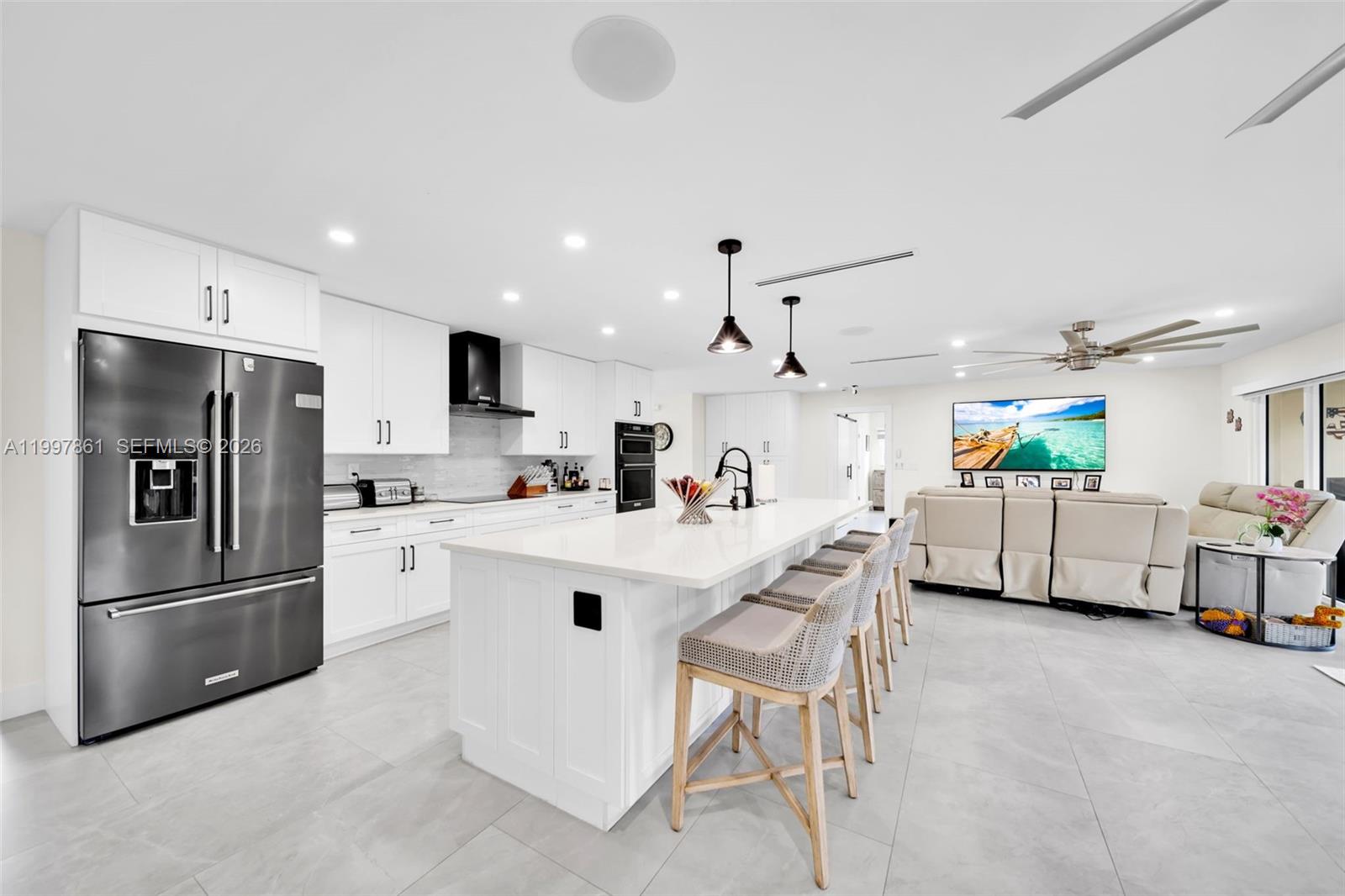 1574 Ricardo Avenue Fort Myers, FL 33901 - Photo 35 of 59 a kitchen with stainless steel appliances a refrigerator sink and white cabinets