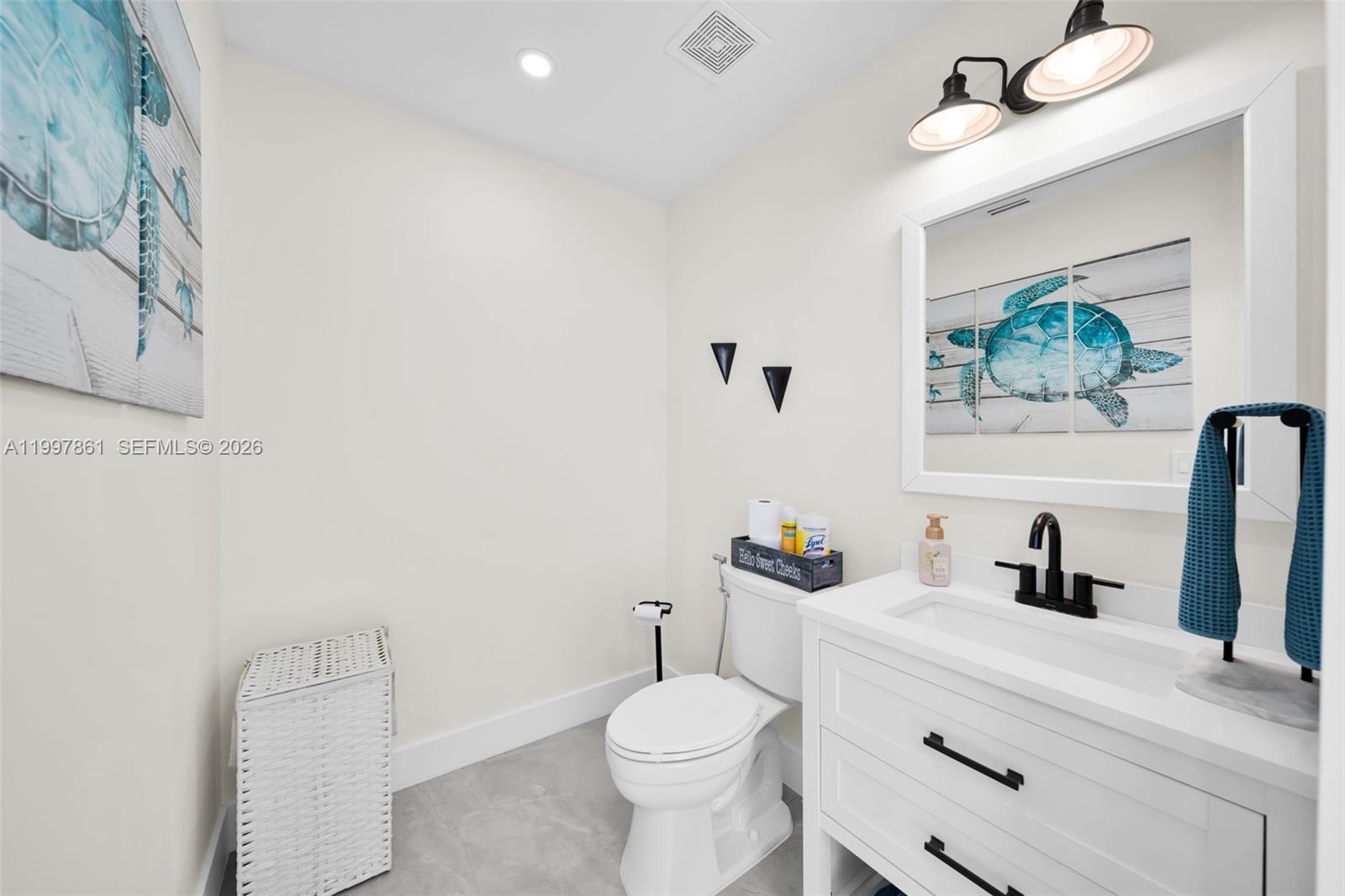 1574 Ricardo Avenue Fort Myers, FL 33901 - Photo 44 of 59 a bathroom with a toilet a sink and mirror