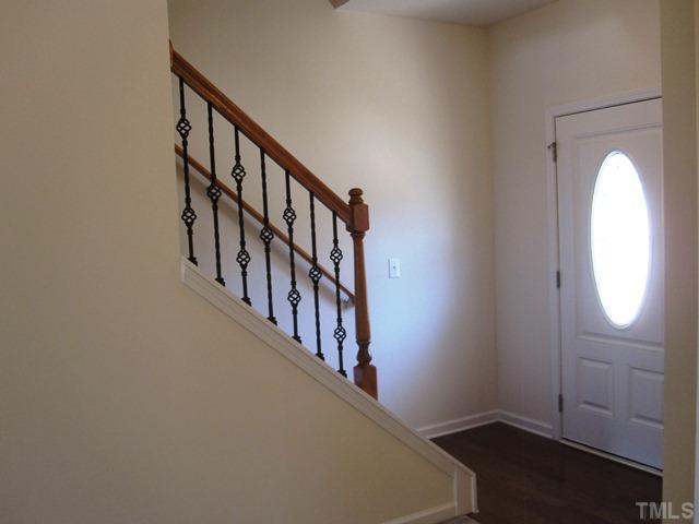 2540 Follow Me Way, Unit LOT65 Raleigh, NC 27610 - Photo 3 of 16 Interior view of decorator front door - hardwood floor foyer and wrought iron railing.