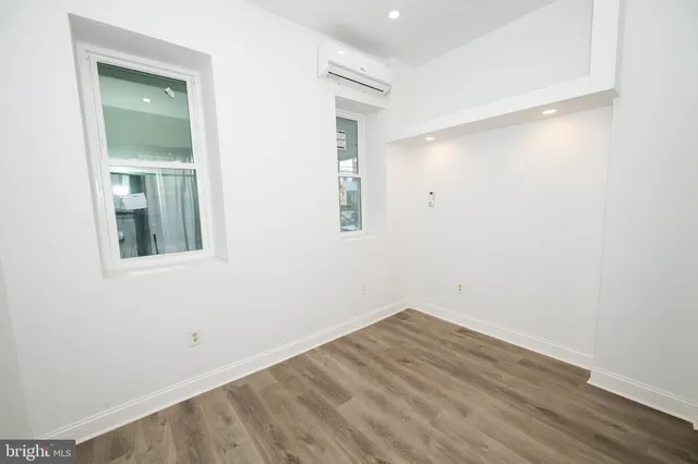 an empty room with a mirror and a window