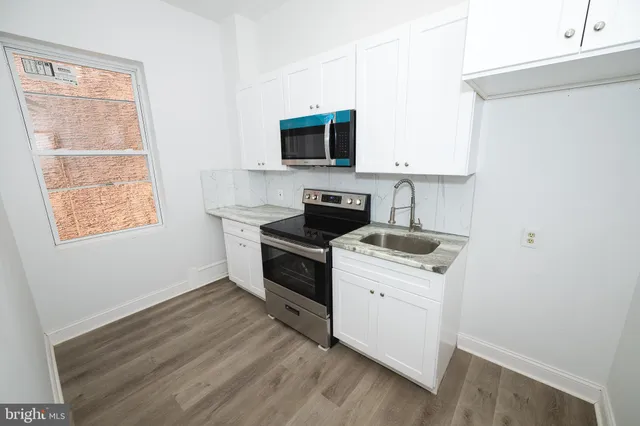 a kitchen with a stove and a microwave