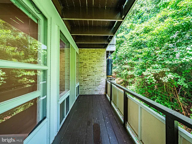 a view of balcony with wooden floor
