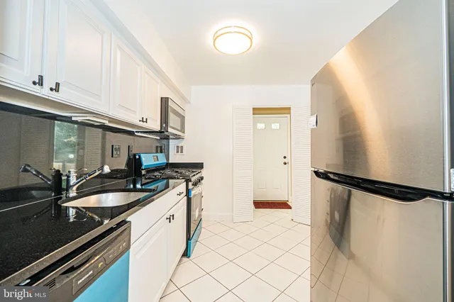 a kitchen with a sink and a refrigerator