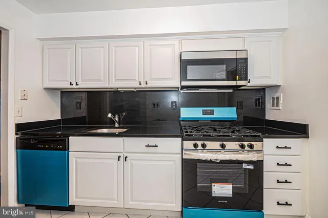 a stove top oven sitting inside of a kitchen