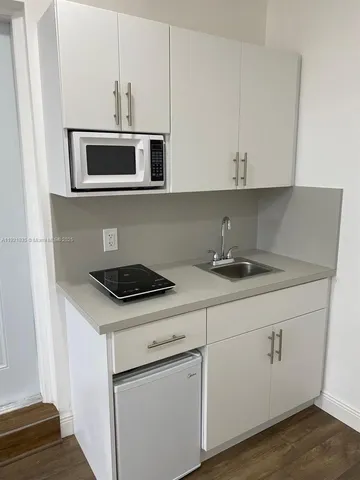 a kitchen with stainless steel appliances granite countertop a sink and a microwave