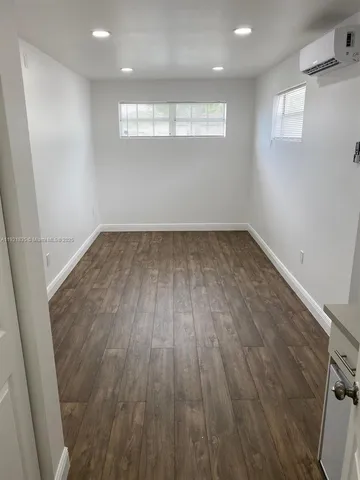 an empty room with wooden floor
