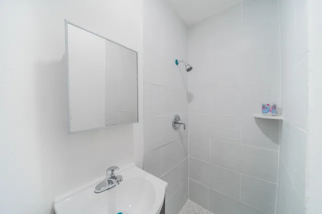a bathroom with a sink and shower