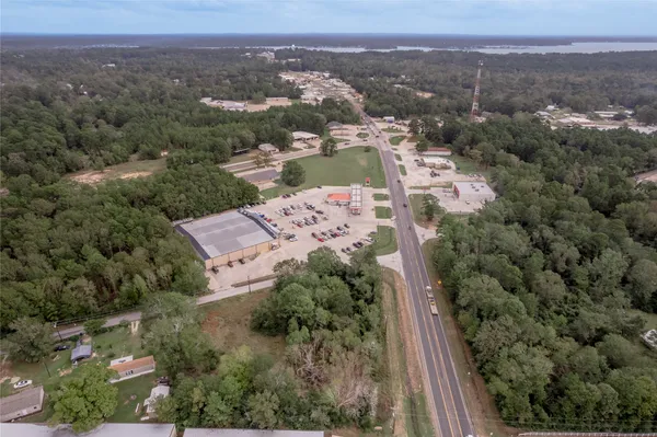 an aerial view of a house with a mountain