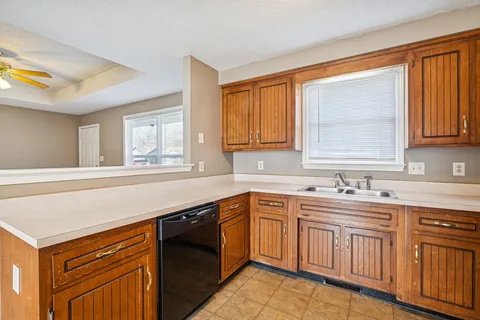 a kitchen with stainless steel appliances granite countertop a refrigerator a sink and a stove