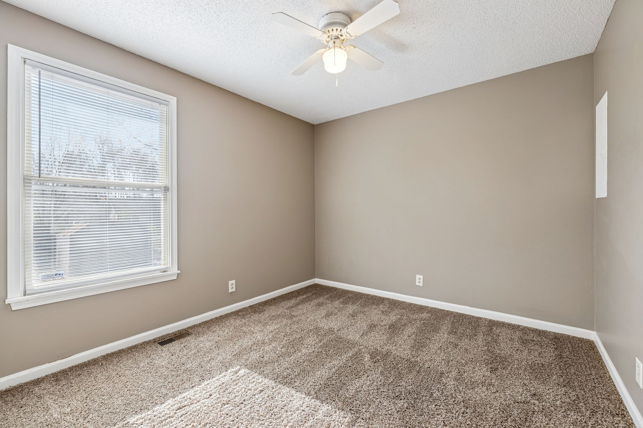 730 Inver Lane Clarksville, TN 37042 - Photo 19 of 32 an empty room with a window and a fan