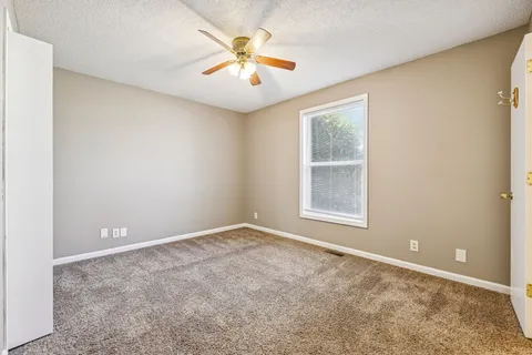a view of a big room with closet and a chandelier fan