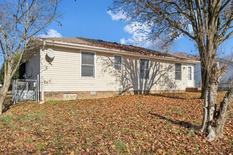 a view of house with snow on the side of the road