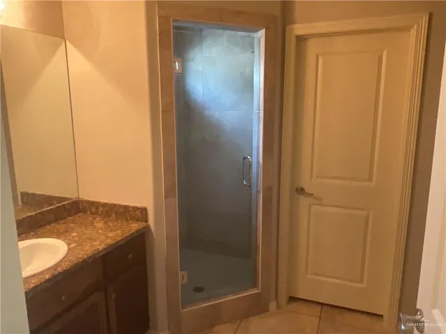 a bathroom with a glass shower door
