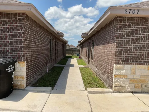 a view of a pathway both side of house
