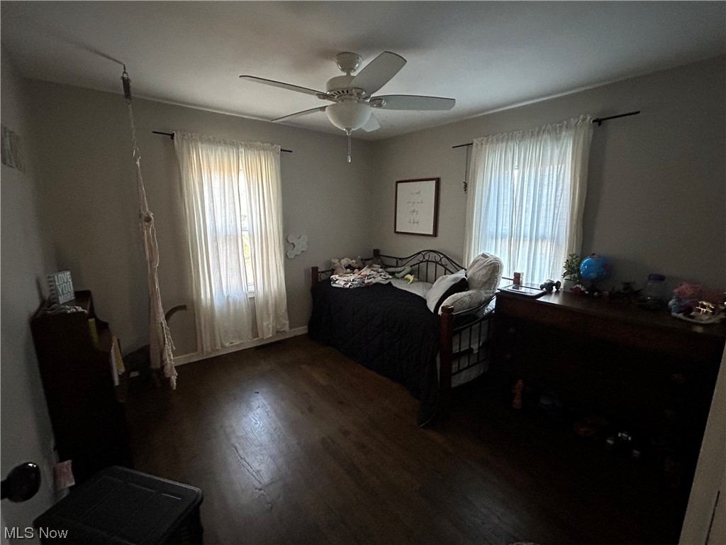1312 Aberagg Road Atwater, OH 44201 - Photo 12 of 23 Bedroom featuring dark wood-type flooring, ceiling fan, and multiple windows
